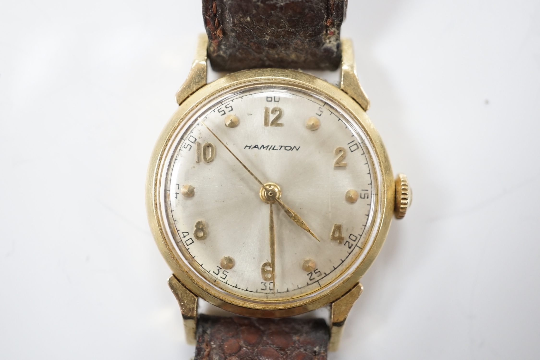 A gentleman's 14k Hamilton manual wind wrist watch, with Arabic dial, on associated leather strap.